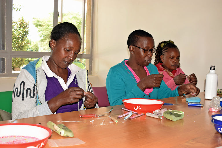 Women with children with special needs being trained on beadwork at Ubuntu Life Foundation Kenya