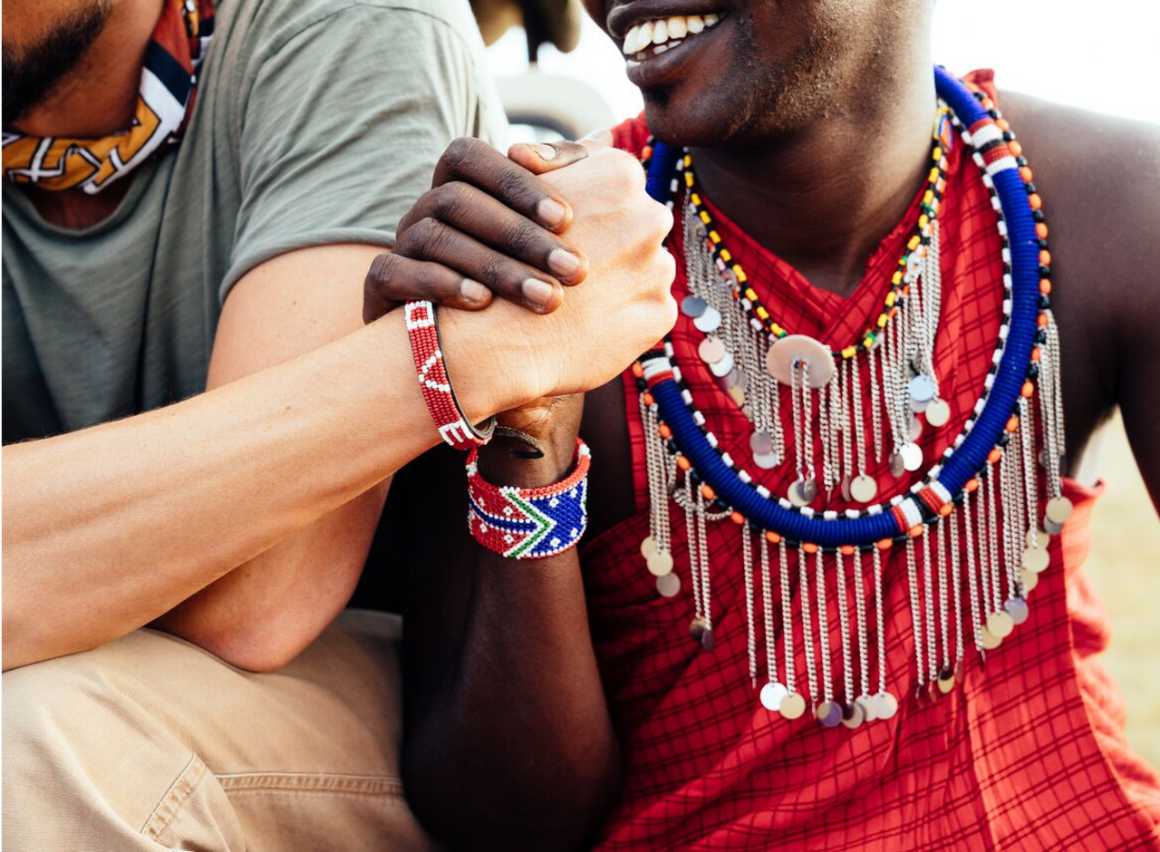 Two shaking hands with bracelets